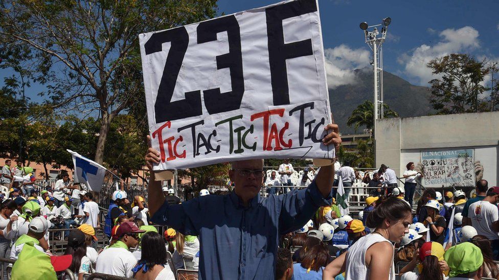 "Aid and Freedom Venezuela Coalition" holds a placard in caracas