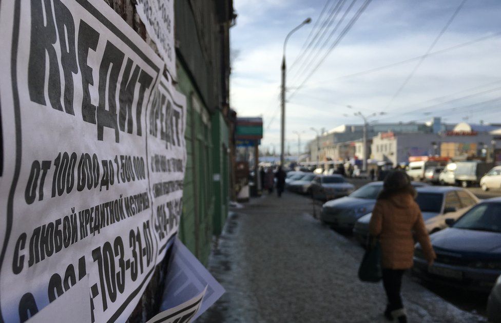 Flyers are daubed on walls on Irkutsk promising cheap credit