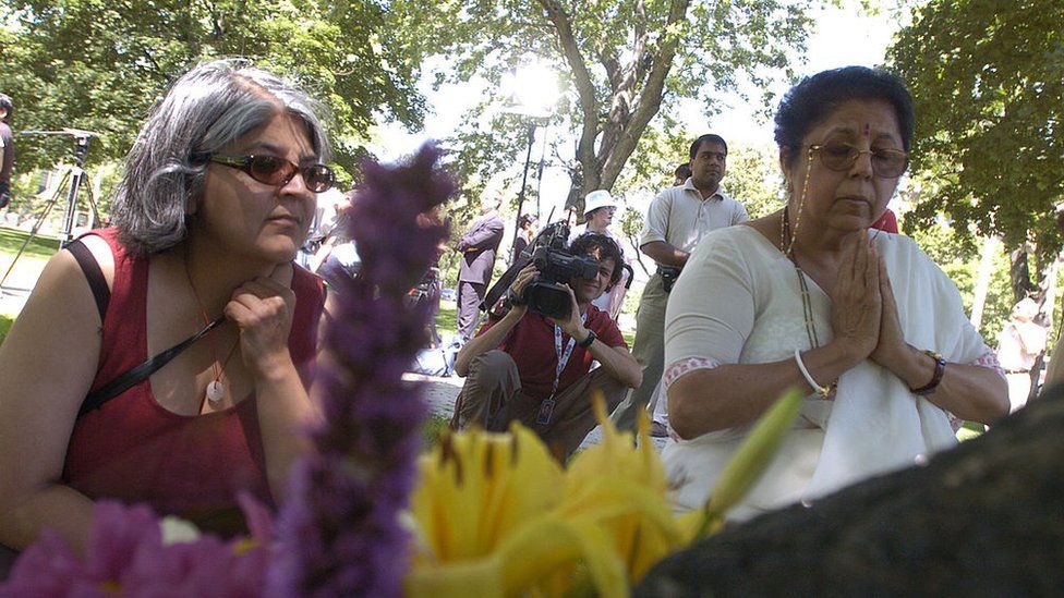 06/23/05 - TORONTO, ONTARIO -Kavita Berry and daughter (on left) Sujata Berry pray and mourn the loss of her son/brother, Sharad Berry,16 yrs at the time at the 1985 Air India tragedy. Air India commemoration at noon on the lawn of Queen's Park, where the plaque is next to the tree that was planted for the victims 15 years ago.