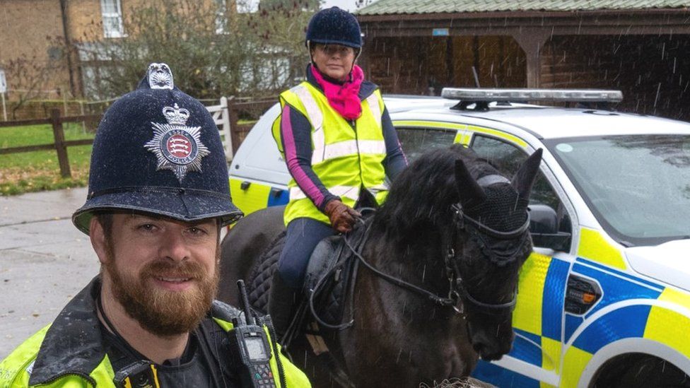 Police officer and woman on a horse
