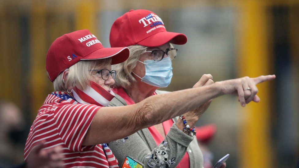 Two female Trump voters in campaign attire