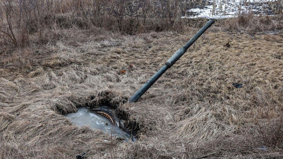The turret of a destroyed Russian tank pokes out from a swamp in Shandryholove village, Donetsk