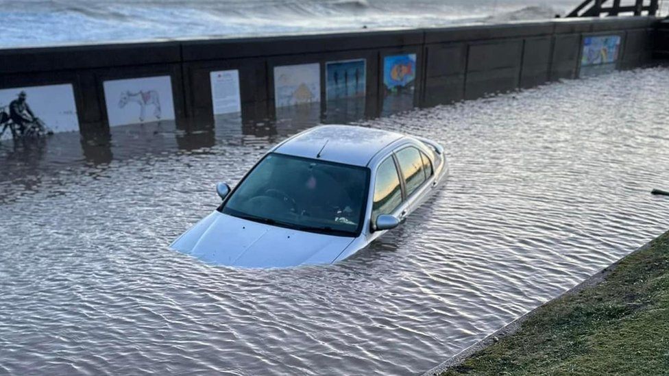 A car floating in floodwater on South Promenade, Hornsea