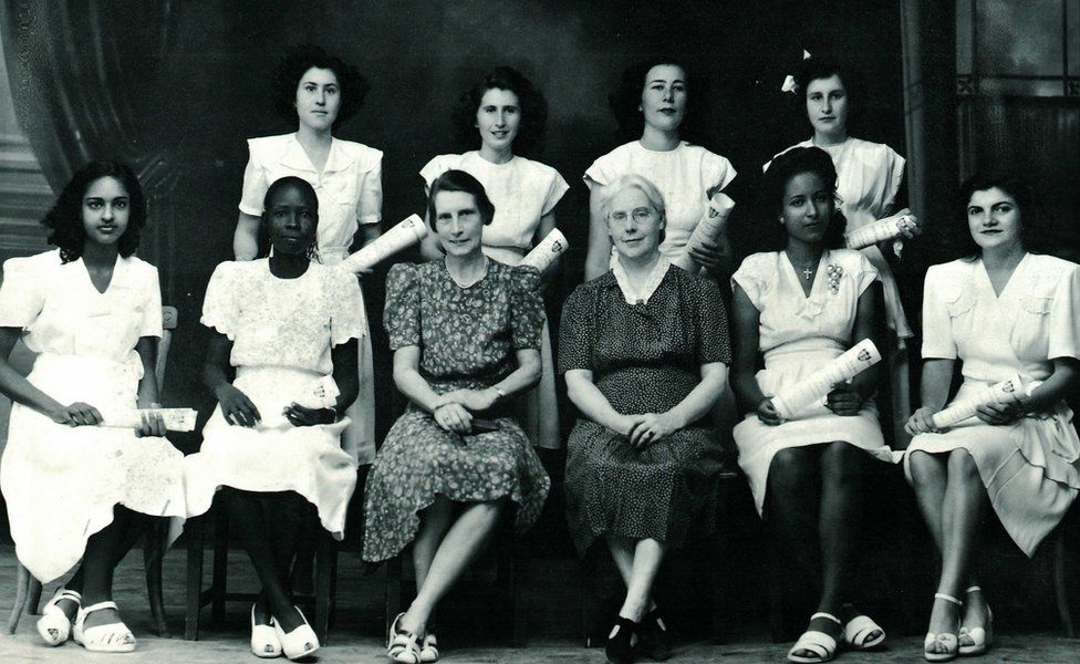 Girls sitting for a school photograph