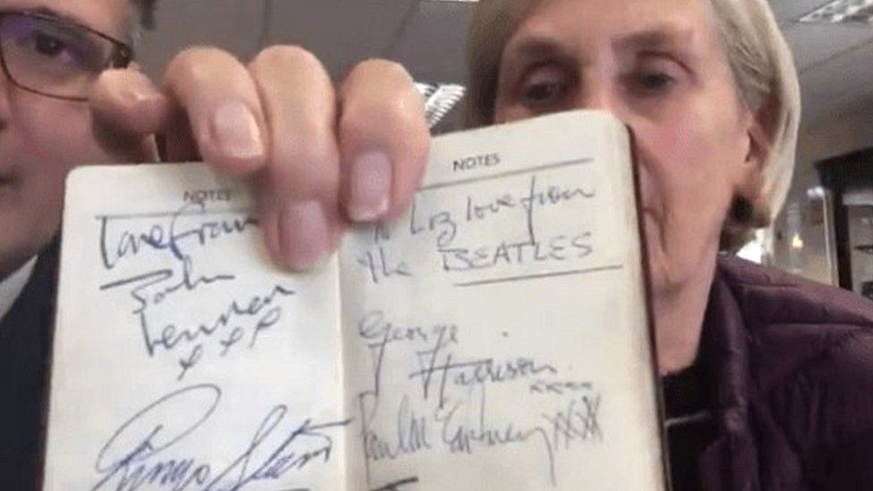 Liz Webster shows her autographs