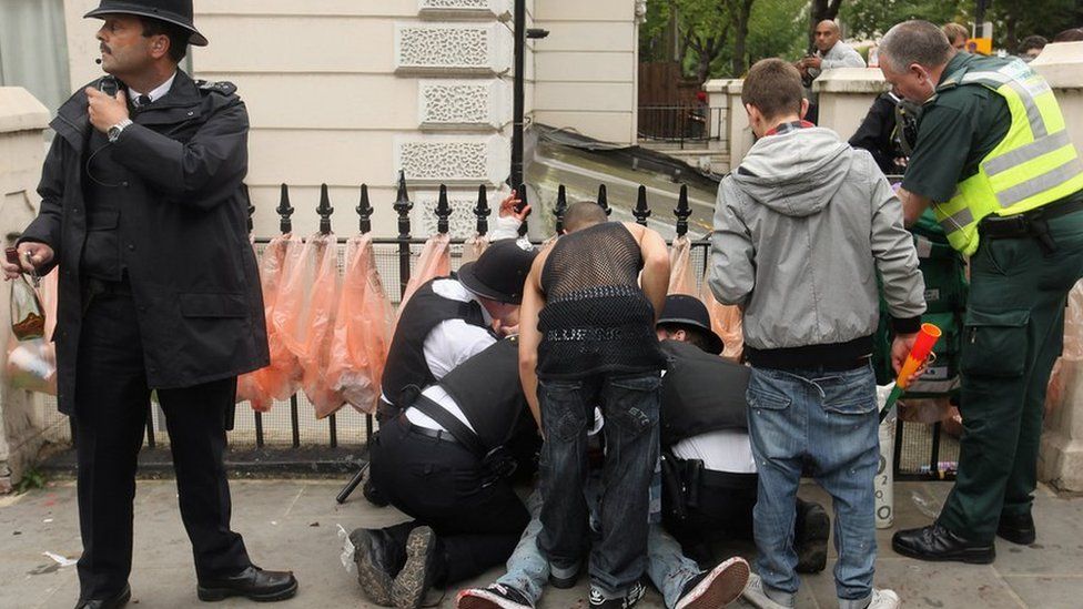 A man is given emergency medical treatment after being stabbed in the stomach at the Notting Hill Carnival in 2011