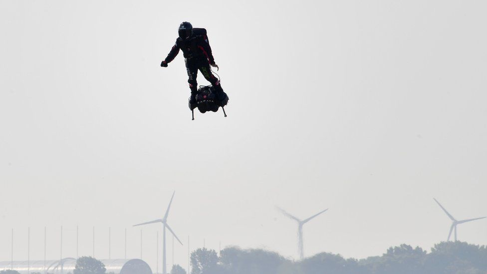 Franky Zapata stands on his jet-powered flyboard as he takes off