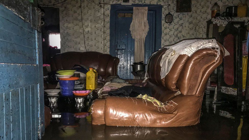 A leather sofa in a flooded living room