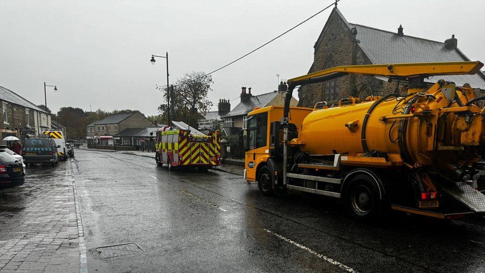 Emergency vehicles in Lanchester where the water has been cleared away