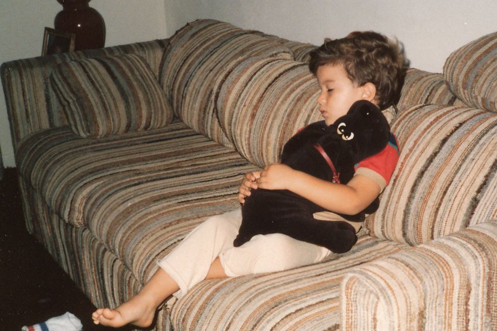 Salinas as a child, sleeping on a sofa