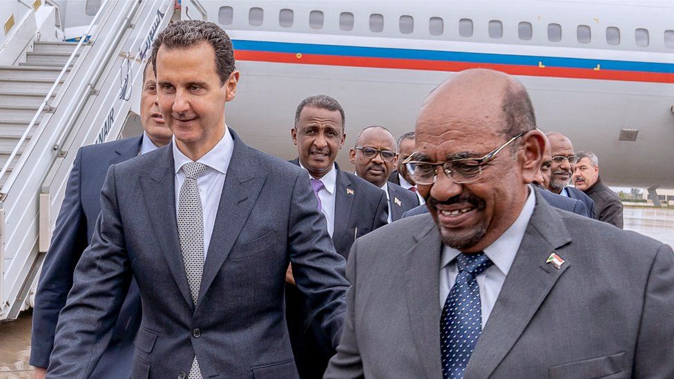 Omar al-Bashir (R) seen visiting President Assad in Syria in December 2018