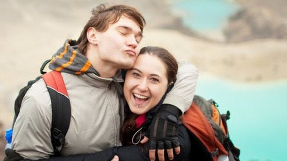 A happy couple at Tongariro Alpine Crossing, a popular tourist attraction in New Zealand.