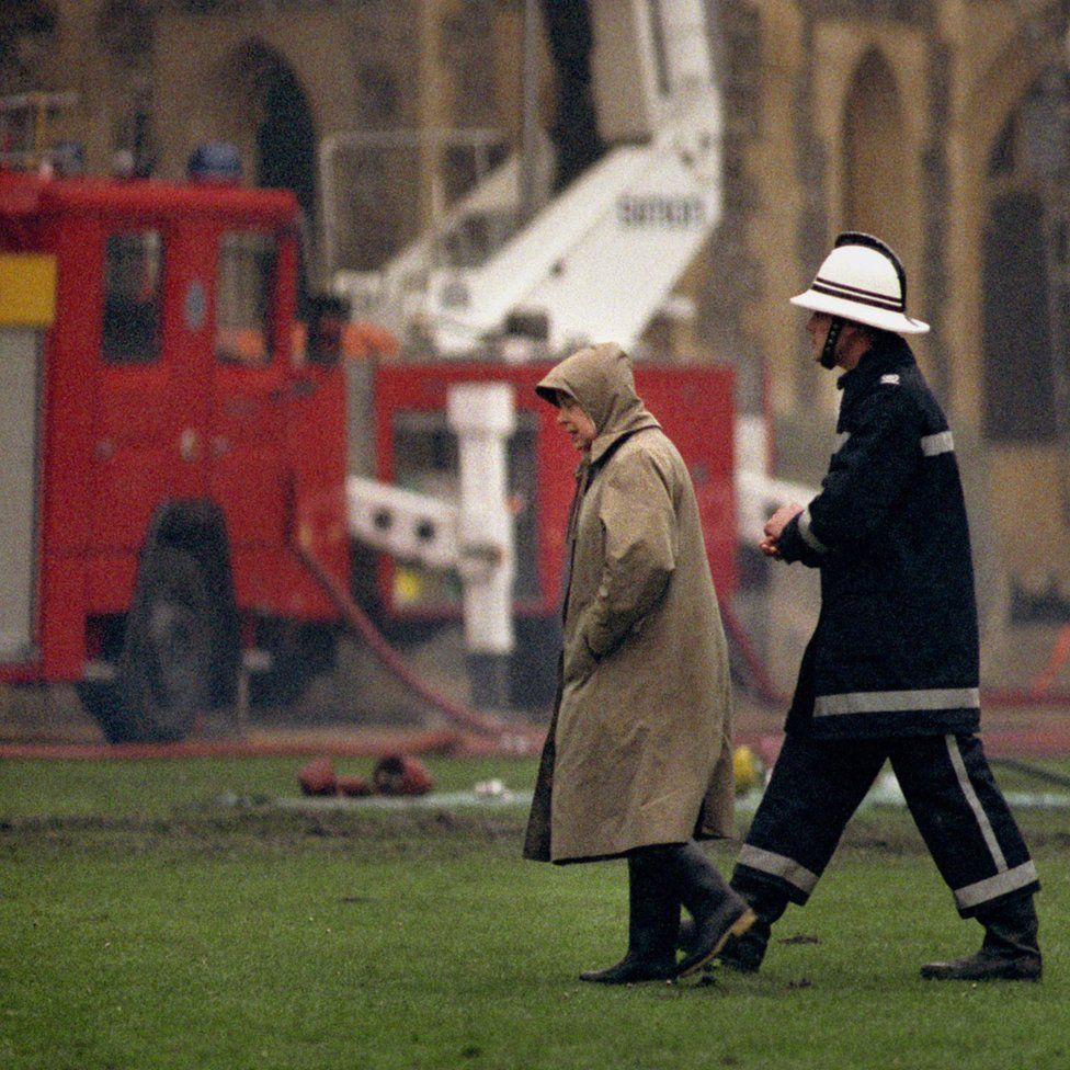 Queen Elizabeth II surveying the scene following the fire at Windsor Castle