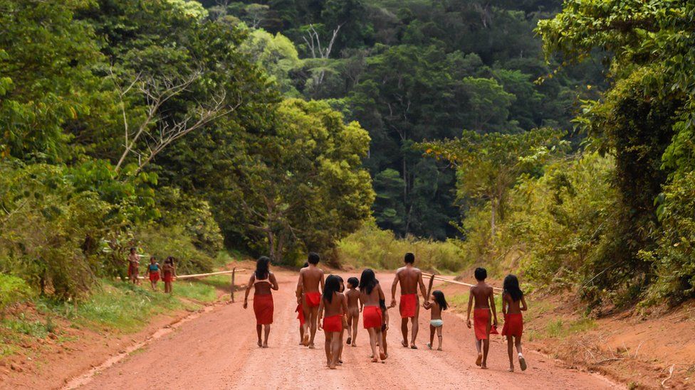 Brazilian Waiapi walk on the road of the Waiapi indigenous reserve, at Pinoty village in Amapa state in Brazil on 12 October 2017