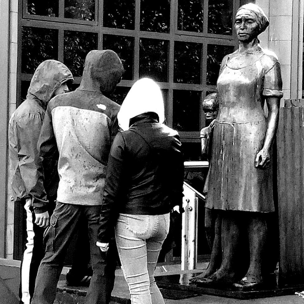 People looking at statue
