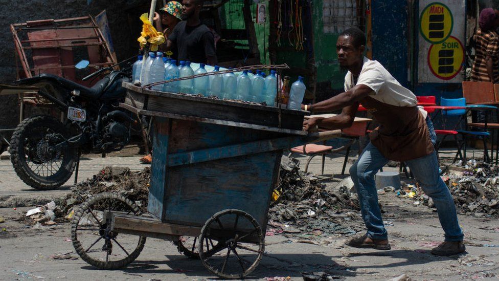 A street vendor flees from gang violence in Haiti's capital city, Port-au-Prince