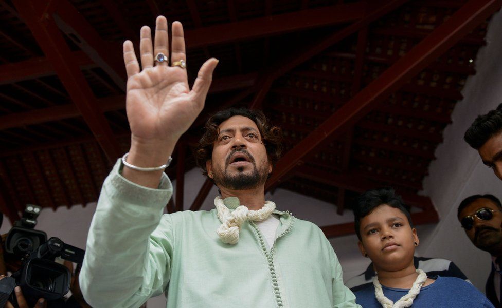 Indian actor Irrfan Khan speaks to the media next to his son Aayan at the Mahatma Gandhi Ashram in Ahmedabad on June 19, 2016, on Father's Day.