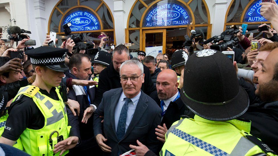 Claudio Ranieri is mobbed leaving an Italian restaurant in Leicester