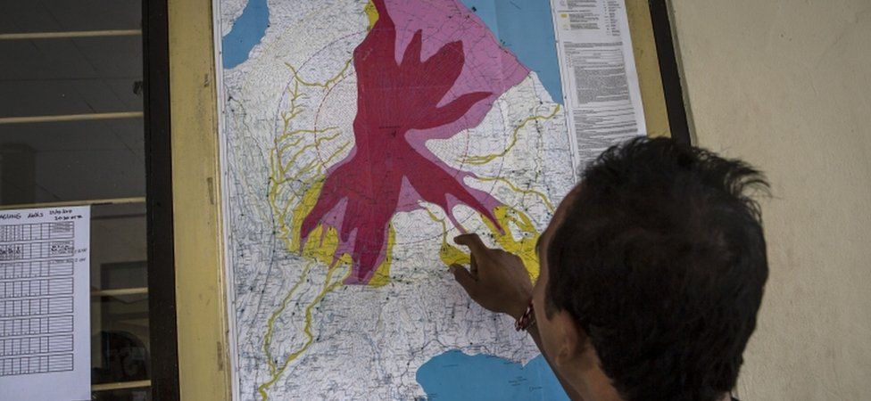 A man looks at a hazard map in Bali, Indonesia