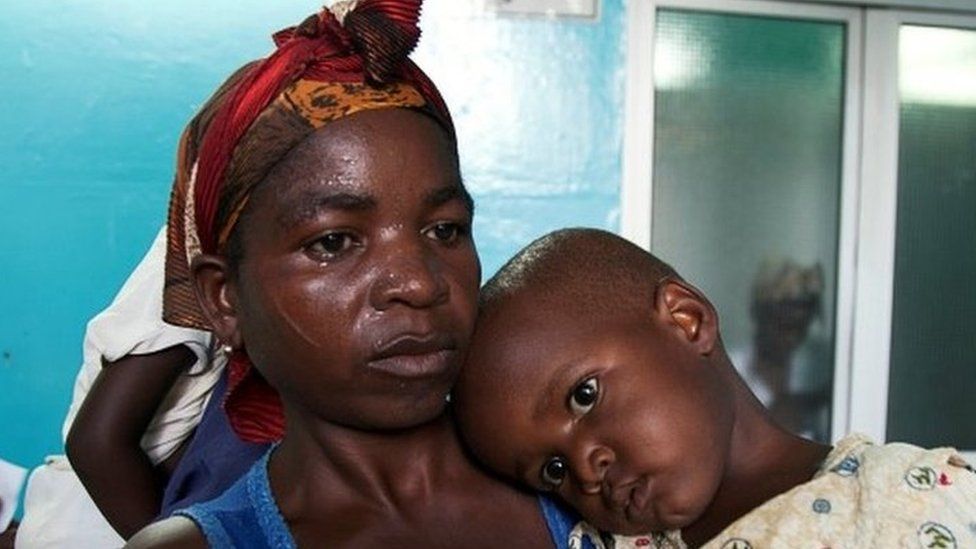 A mother holds her child suffering from yellow fever at a hospital in Luandaâ€‹, Angola, March 15