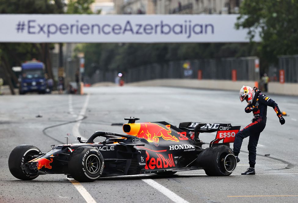 Max Verstappen of the Netherlands and Red Bull Racing kicks his tyre as he reacts after crashing during the F1 Grand Prix of Azerbaijan