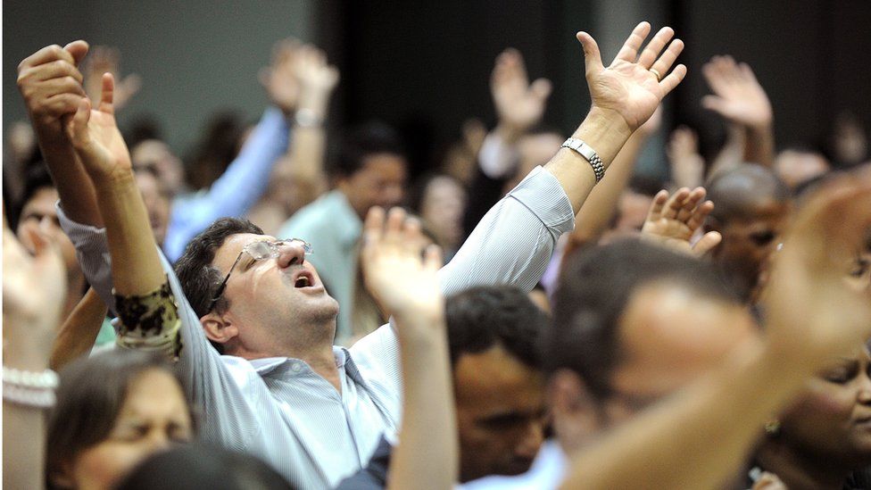 People attend a mass in evangelical church in Goiania, Goias State, Brazil, on May 19, 2013.