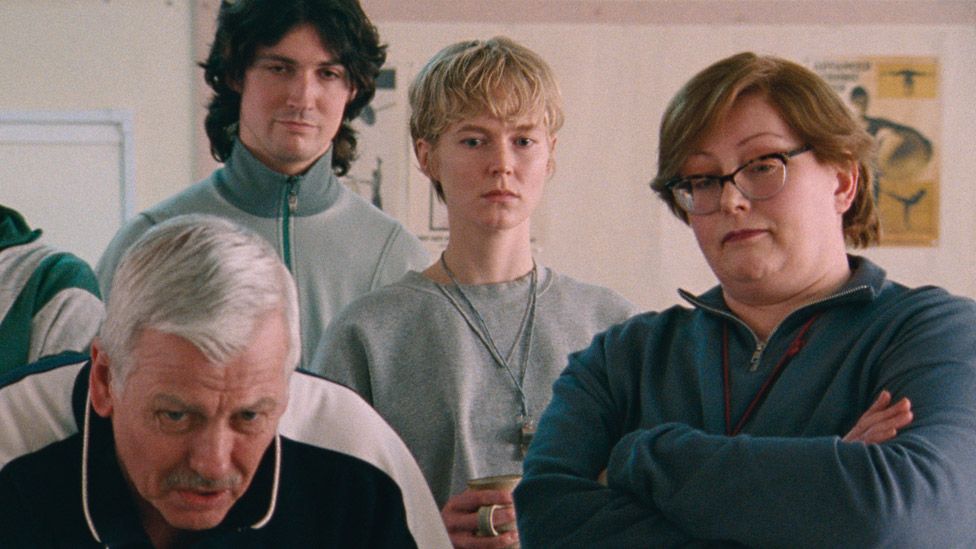 A still from Blue Jean with teachers watching the TV in the staff room