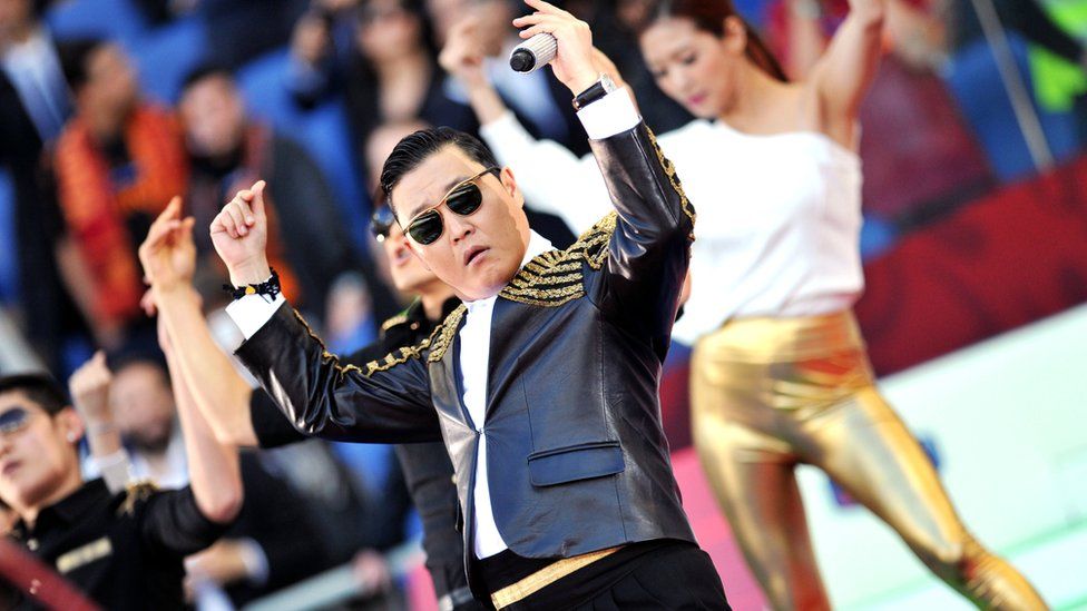 Korean pop artist Park Jae Sang (C), popularly known as 'Psy', sings as he performs his 'Gangnam Style' song prior to the Italian Cup football final between AS Roma and Lazio at the Rome's Olympic stadium on May 26, 2013