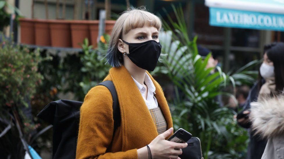 Woman in face mask at outside market
