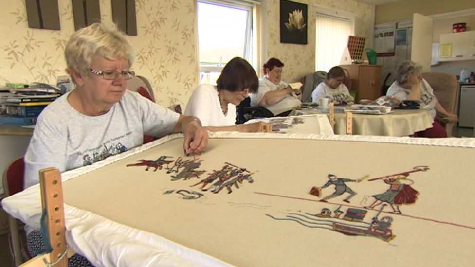Women stitching tapestry