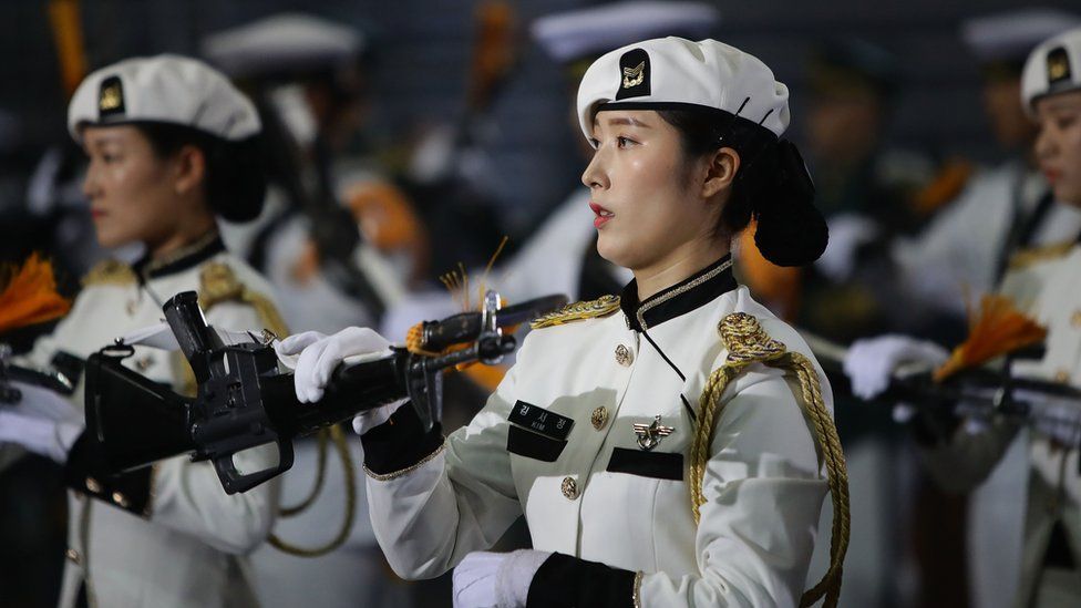 A female South Korean solider performs during the 64th anniversary of the Korean war armistice agreement.