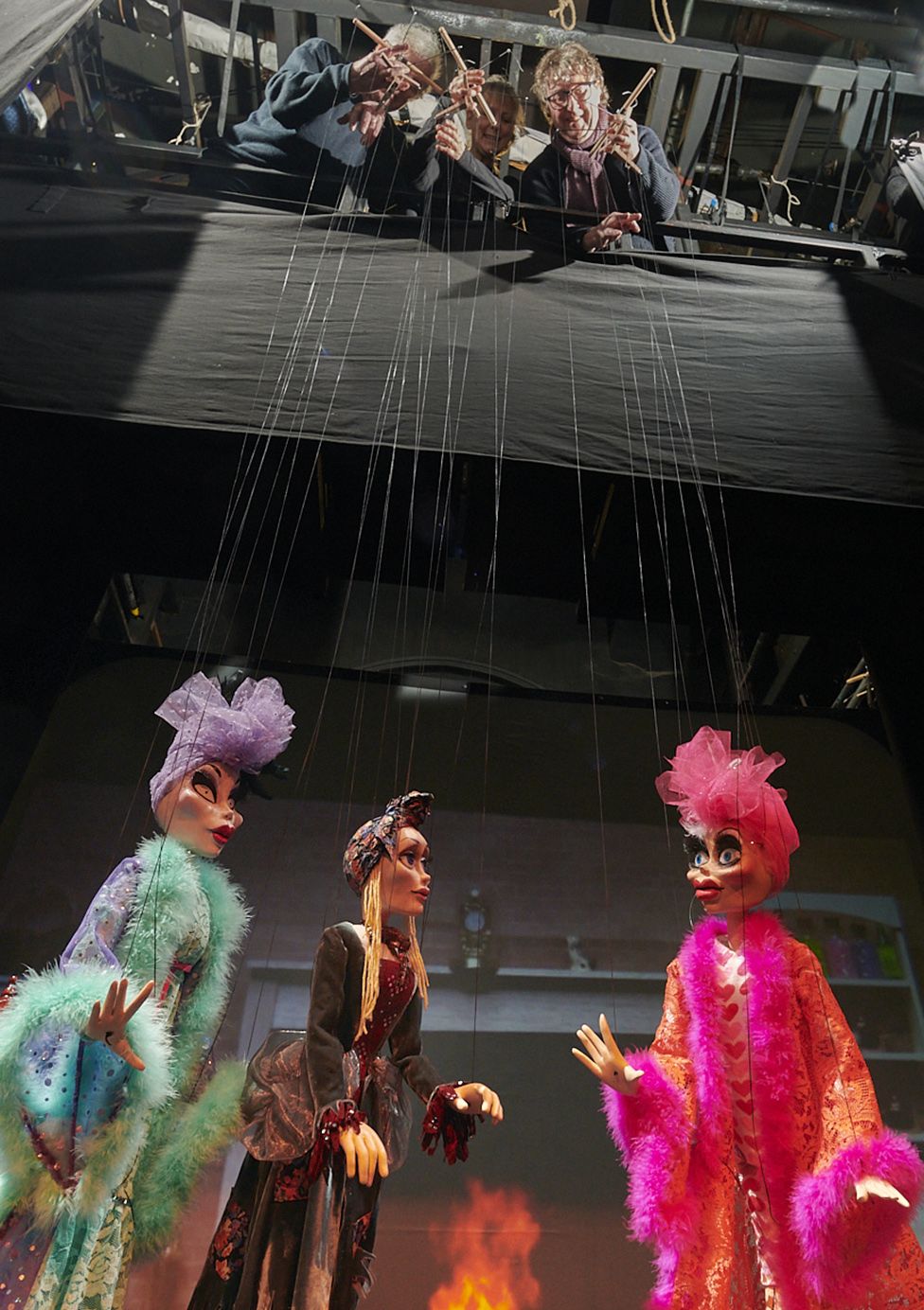 Puppeteers high above the stage at the Norwich Puppet Theatre operating Cinderella marionettes