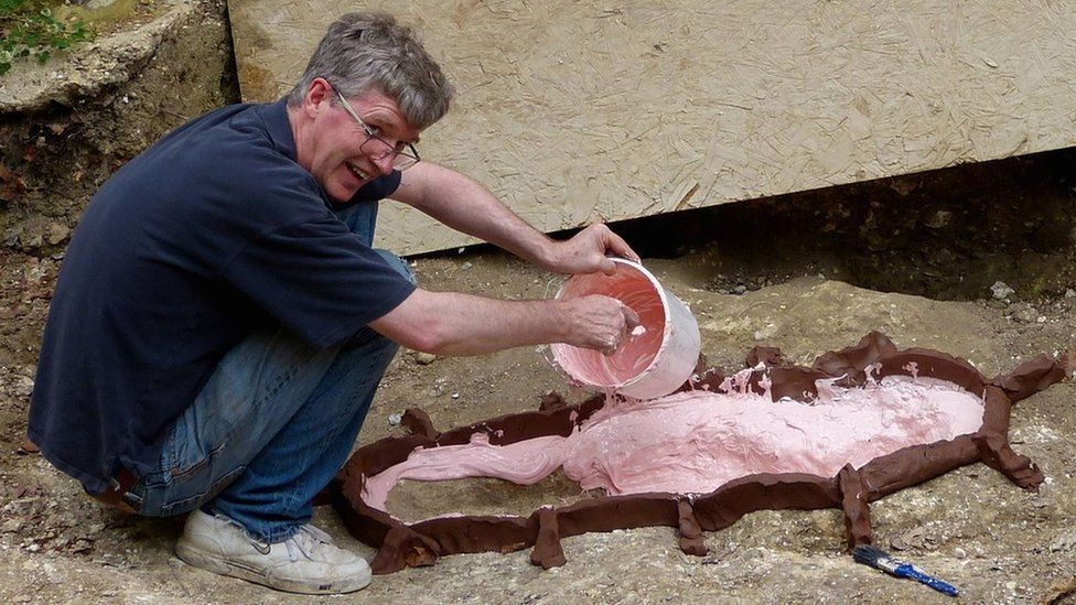 Making a mould of a child's grave