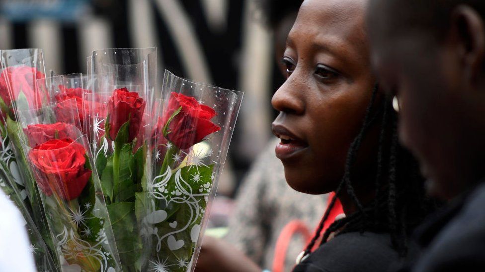 A woman buys roses for Valentine's Day at a flower shop in Nairobi