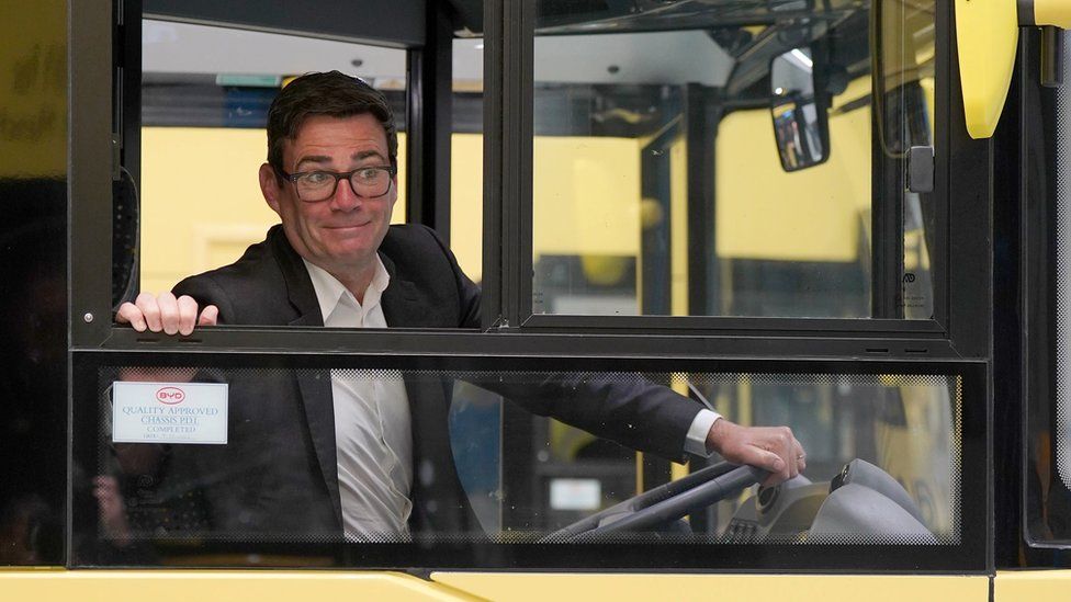 Andy Burnham at the wheel in bus driver's cab