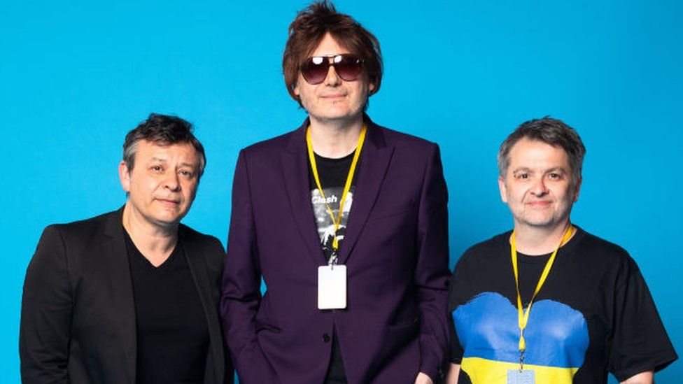 BIRMINGHAM, ENGLAND - MARCH 29: (L-R) James Dean Bradfield, Nicky Wire and Sean Moore of Manic Street Preachers pose backstage during a Concert for Ukraine at Resorts World Arena on March 29, 2022 in Birmingham, England. All proceeds from Concert for Ukraine are being donated to Disasters Emergency Committee's Ukraine Humanitarian Appeal. (Photo by Tristan Fewings/Disasters Emergency Committee/Getty Images for Livewire Pictures Ltd)