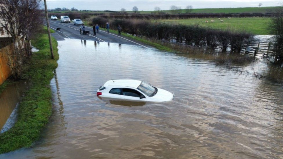 A car stuck in flood water at Dunham Bridge