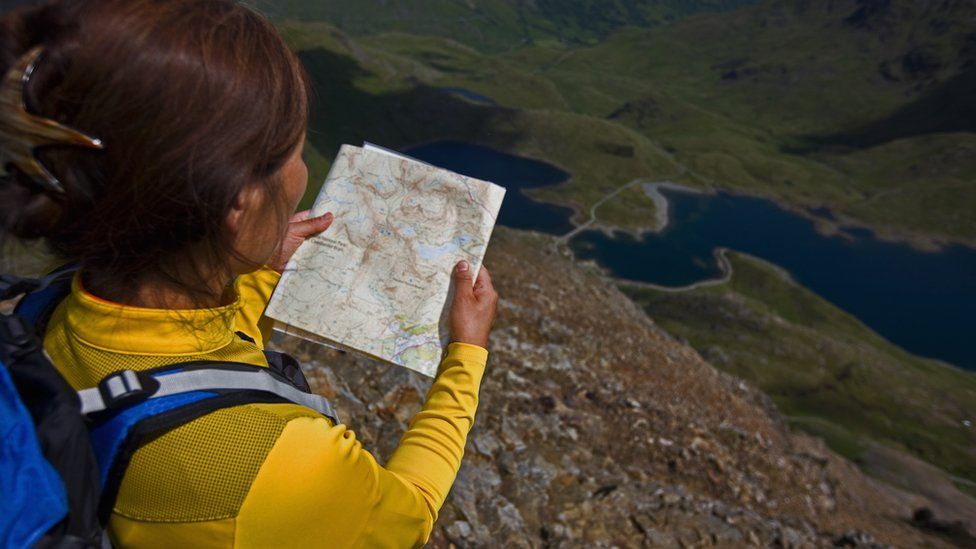 Woman reading a map in Snowdonia