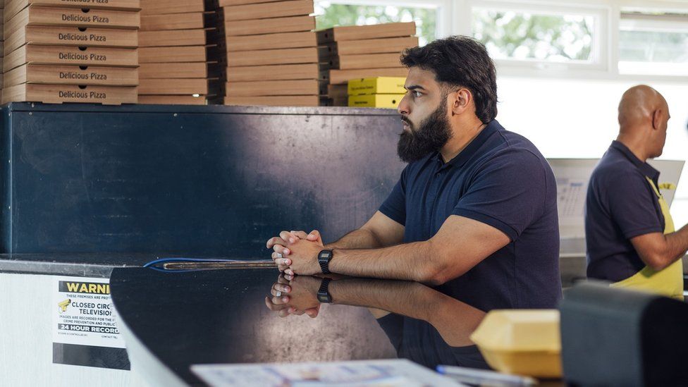 Staff in a pizza takeaway