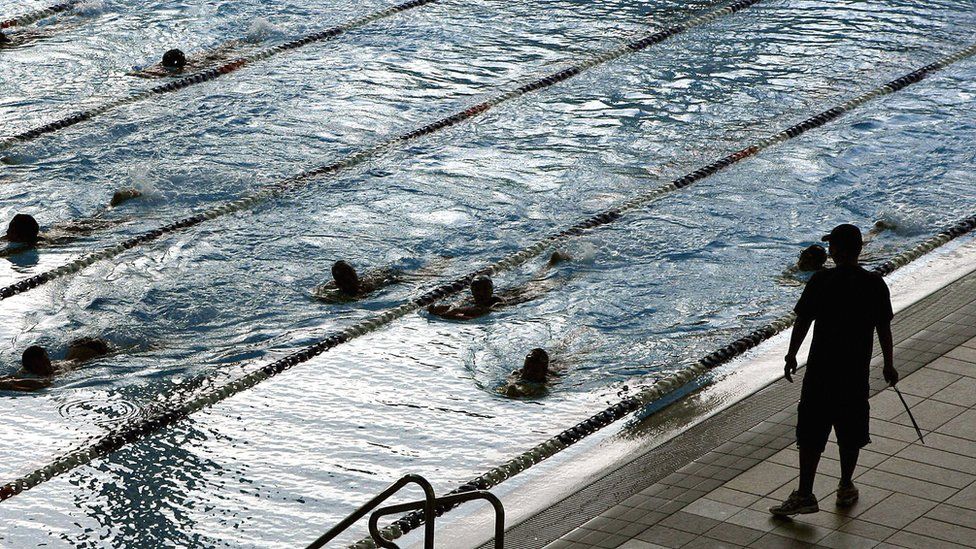 File photo: Students swim across the pool during a training session, Singapore, 2006
