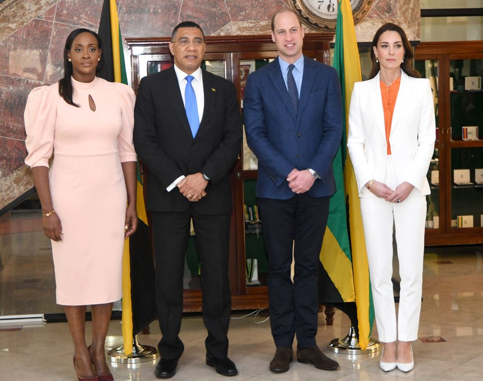 Prince William and Catherine, the Duchess of Cambridge (as they were then) pose with Jamaican Prime Minister Andrew Holness and his wife Juliet during their meeting at the PM's residence in Kingston on 23 March 2022. None are smiling except William.