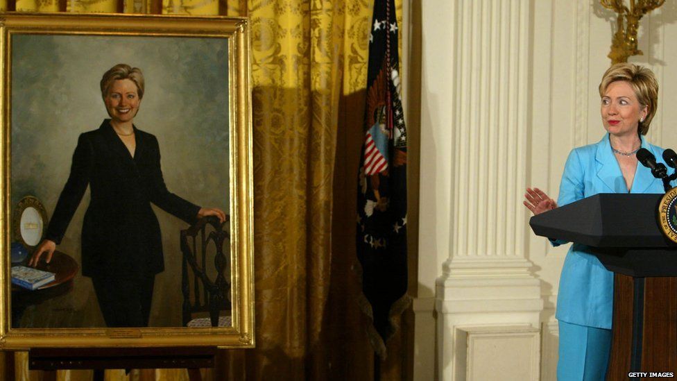 Former First Lady Hillary Clinton next to her portrait in the East Room of the White House in 2004