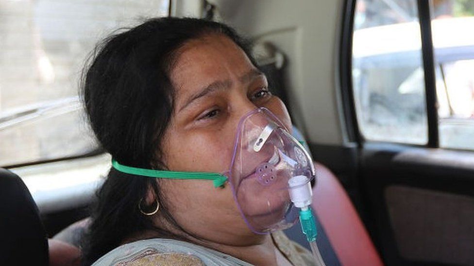 A Covid-19 patient gets oxygen on the spot provided by Sikh Organization at Gurdwara in Indirapuram, Ghaziabad, Uttar Pradesh, India on April 24, 2021. India put oxygen tankers on special express trains as major hospitals in Delhi NCR to save COVID-19 patients who are struggling to breathe. (