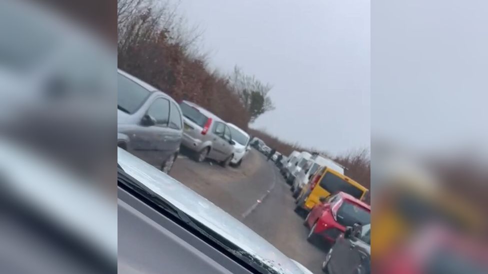 Cars parked on a countryside road