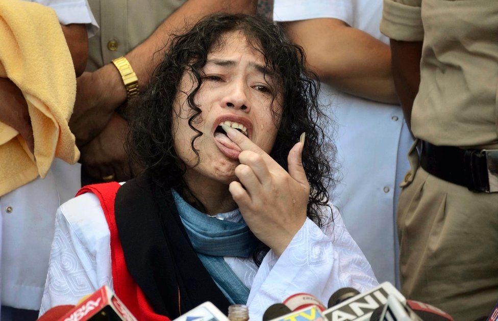 Indian political activist Irom Sharmila licks honey from her hand to break her fast in Imphal, north-eastern Indian state of Manipur, India, Tuesday, Aug. 9, 2016