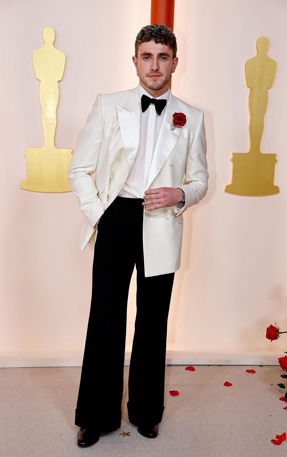 Paul Mescal poses on the champagne-colored red carpet during the Oscars arrivals at the 95th Academy Awards in Hollywood, Los Angeles, California, U.S., March 12, 2023