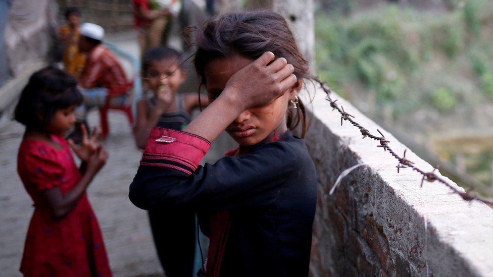A Rohingya refugee girl wipes her eyes as she cries at Leda Unregistered Refugee Camp in Teknaf, Bangladesh, February 15, 2017