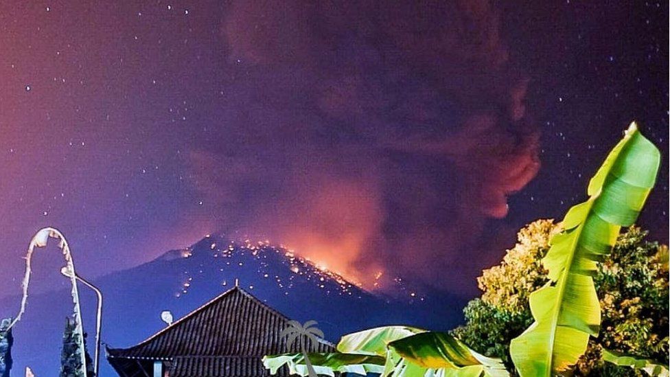Photograph shows smoke and lava coming from volcano in Bali night sky