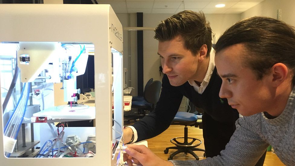 Cellink boss Erik Gatenholm (left) and a member of staff checking on a 3D printer