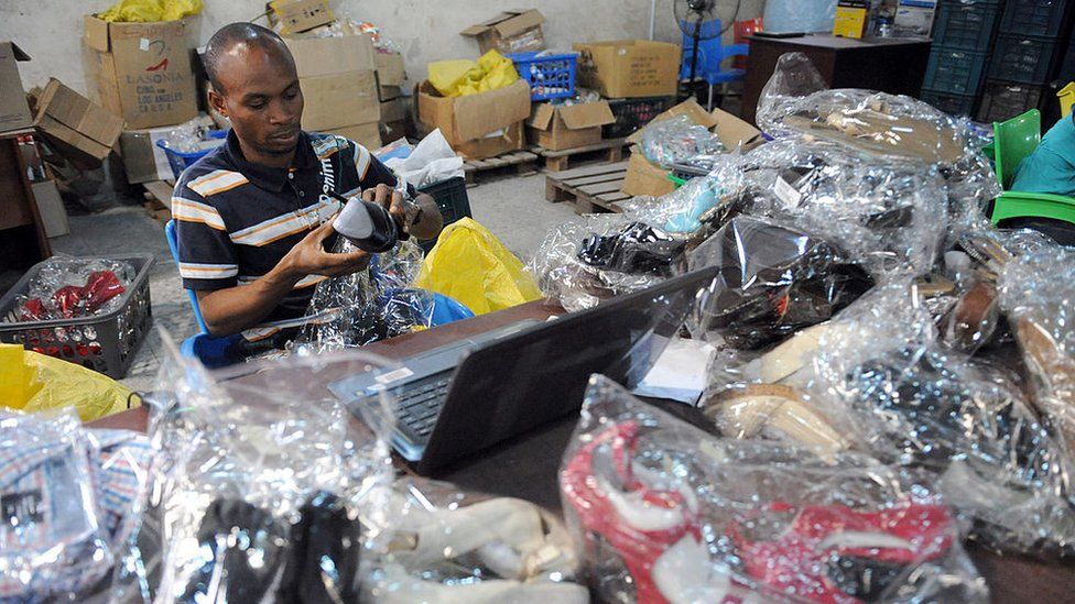 A worker scans products for delivery at the Ikeja warehouse of the company in lagos on June 12, 2013